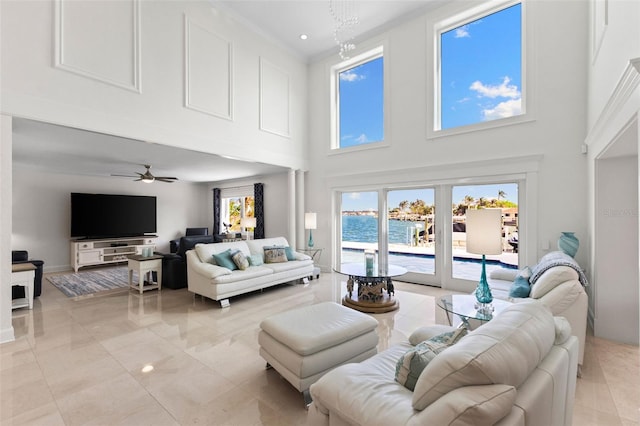 living room featuring a high ceiling and ceiling fan