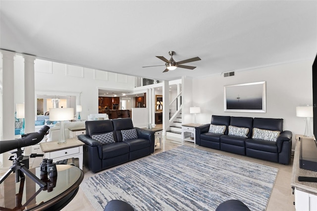 living room with ceiling fan, ornate columns, and crown molding