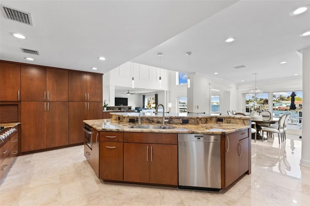 kitchen featuring crown molding, sink, a large island with sink, decorative light fixtures, and dishwasher