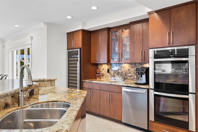 kitchen with light stone counters, sink, and stainless steel appliances