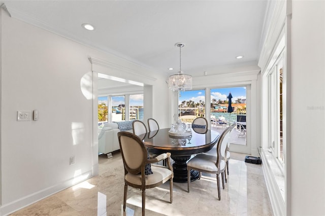 dining space featuring crown molding and a chandelier