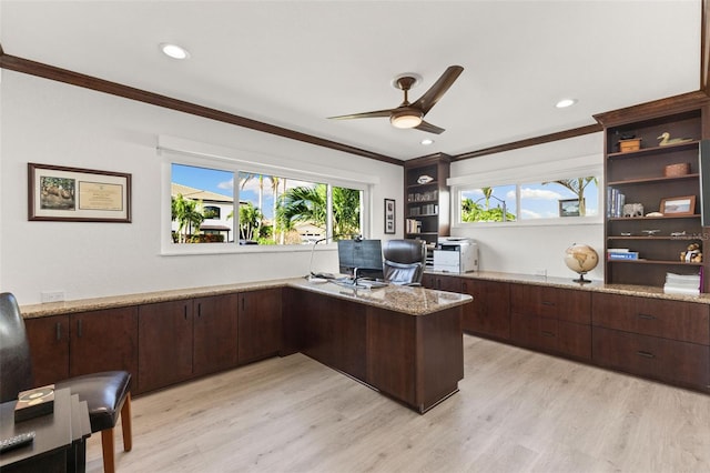 office space featuring ceiling fan, built in desk, crown molding, and light hardwood / wood-style flooring