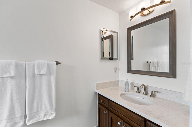 bathroom with vanity and a textured ceiling