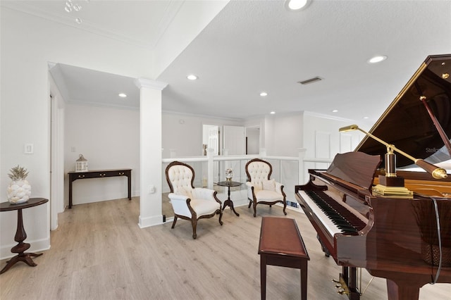 sitting room with ornamental molding, decorative columns, and light hardwood / wood-style floors