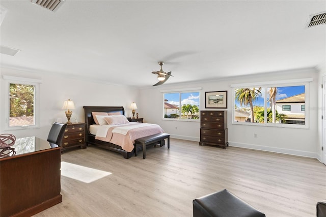 bedroom with light hardwood / wood-style floors, ceiling fan, and ornamental molding