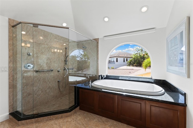 bathroom with tile patterned flooring, lofted ceiling, and shower with separate bathtub