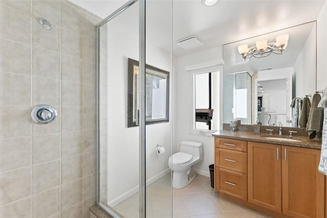 bathroom featuring tile patterned floors, toilet, vanity, and walk in shower