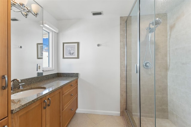 bathroom with tile patterned floors, vanity, and walk in shower