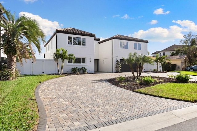 mediterranean / spanish home with a garage and a front yard