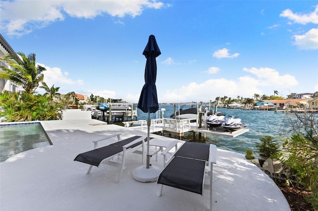 view of patio / terrace with a water view and a dock