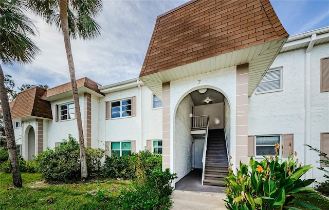211 S Mcmullen Booth Rd Unit 189, Clearwater, FL 33759 - entrance to property with stucco siding, roof with shingles, and mansard roof