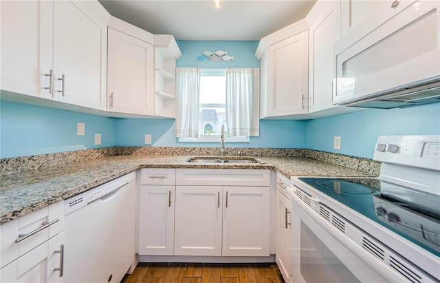 kitchen featuring white cabinets, sink, and white appliances