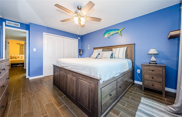 bedroom featuring ceiling fan, a closet, and dark hardwood / wood-style flooring