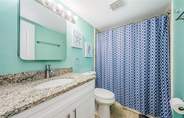 bathroom featuring curtained shower, vanity, tile patterned floors, and toilet