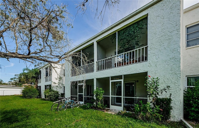 211 S Mcmullen Booth Rd Unit 189, Clearwater, FL 33759 - back of property with stucco siding, a yard, and a sunroom