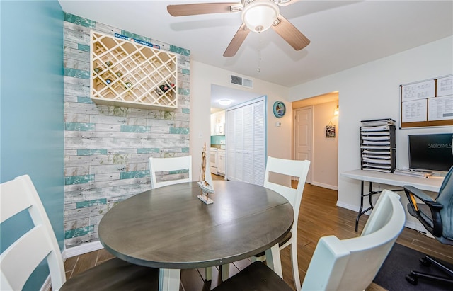 dining area with hardwood / wood-style floors and ceiling fan