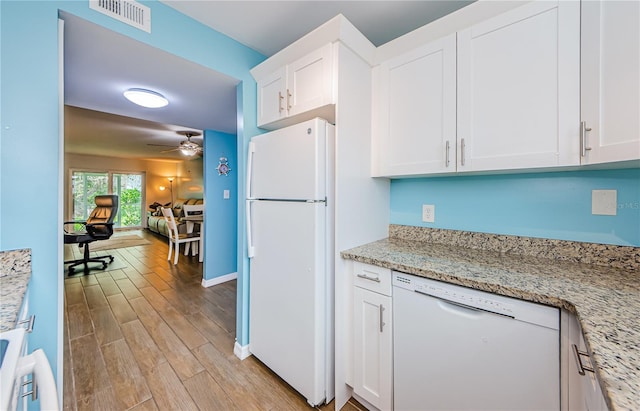 kitchen with white cabinetry, light hardwood / wood-style flooring, light stone counters, and white appliances