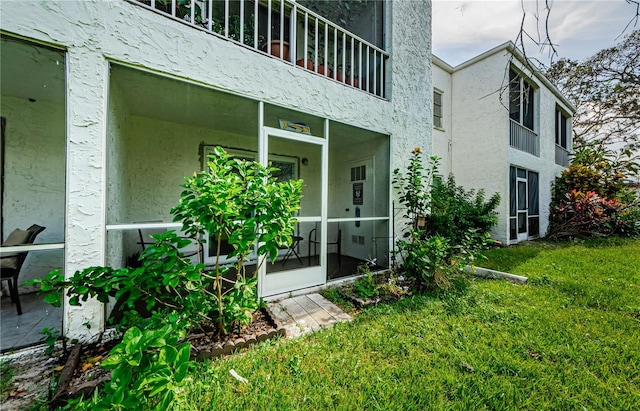 exterior space with a balcony and a yard