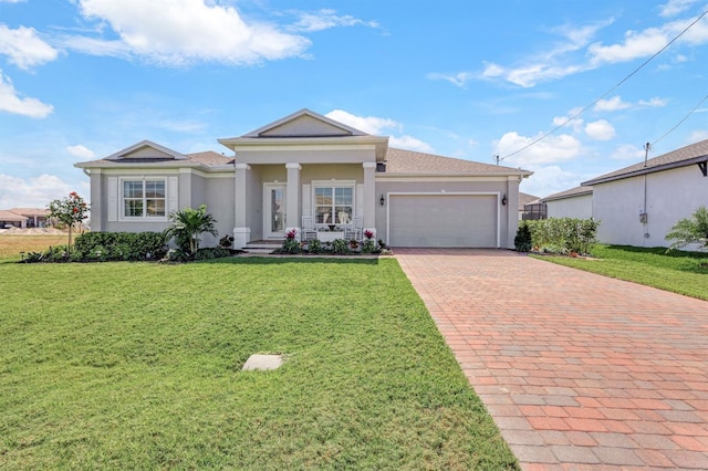 view of front of home featuring a porch, a front yard, and a garage