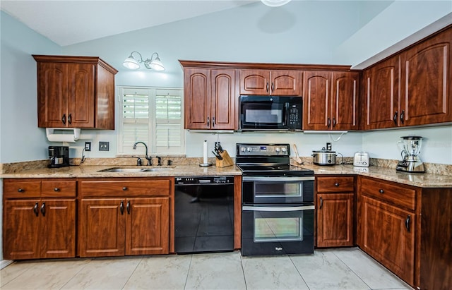 kitchen with light stone counters, sink, black appliances, and lofted ceiling