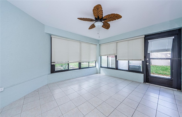 spare room featuring ceiling fan and light tile patterned floors