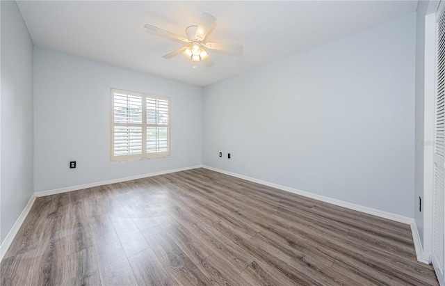 3647 Muirfield Ct, New Port Richey, FL 34655 - unfurnished bedroom featuring dark wood-style floors, baseboards, and a ceiling fan