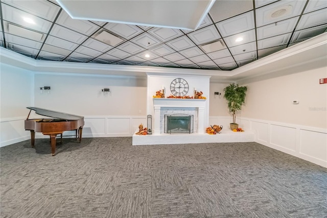 3647 Muirfield Ct, New Port Richey, FL 34655 - carpeted living area featuring a decorative wall, a glass covered fireplace, ornamental molding, a wainscoted wall, and recessed lighting
