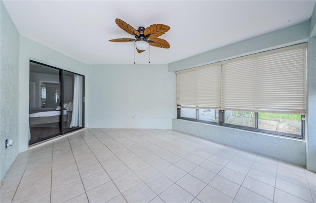 spare room with light tile patterned flooring and ceiling fan