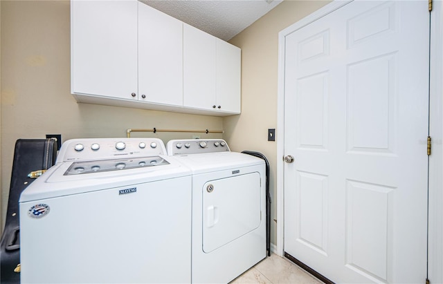 3647 Muirfield Ct, New Port Richey, FL 34655 - laundry area with washer and dryer, cabinet space, and a textured ceiling