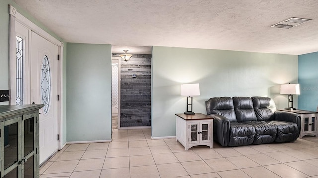 tiled living room with a textured ceiling and wooden walls