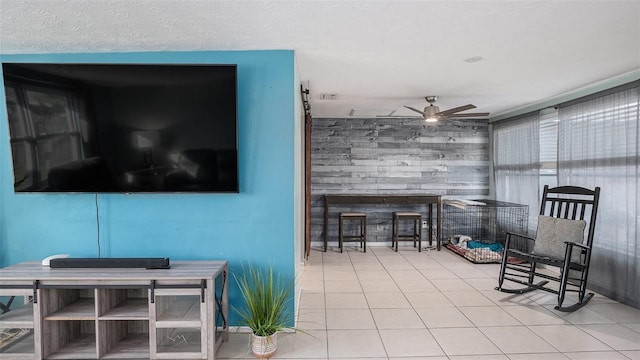 living room featuring a textured ceiling, tile patterned flooring, and ceiling fan