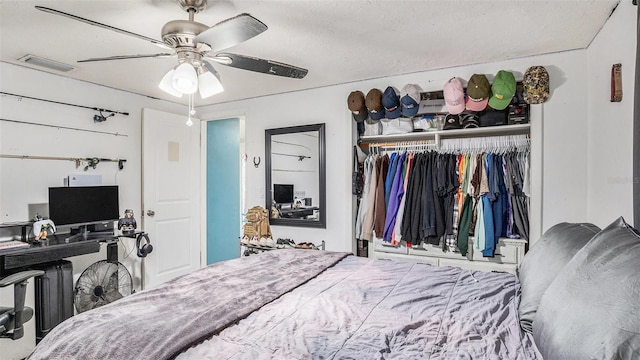 bedroom featuring a closet, a textured ceiling, and ceiling fan