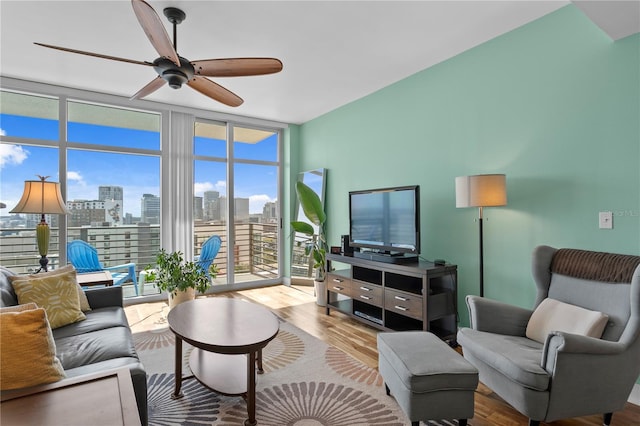 living room featuring floor to ceiling windows, a wealth of natural light, and light hardwood / wood-style floors