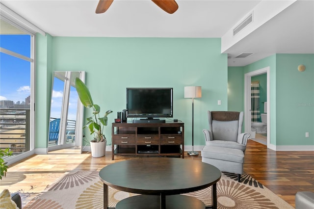 living room with hardwood / wood-style flooring and ceiling fan