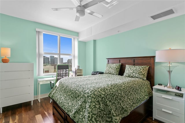 bedroom with ceiling fan and dark hardwood / wood-style floors