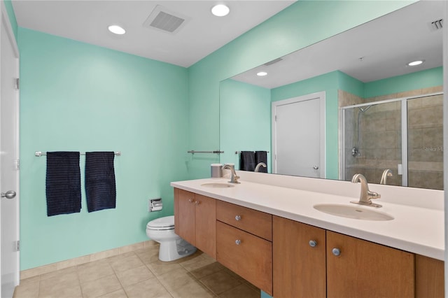 bathroom with tile patterned flooring, vanity, an enclosed shower, and toilet