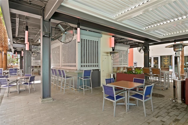 view of patio with ceiling fan, a pergola, and an outdoor bar