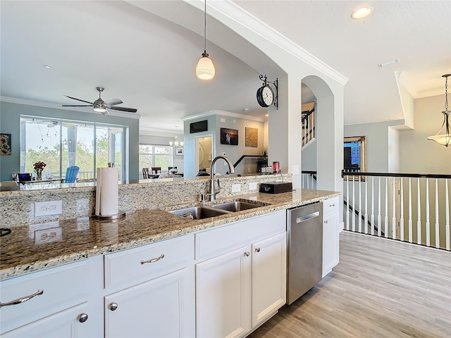 kitchen with crown molding, white cabinetry, hanging light fixtures, sink, and dishwasher