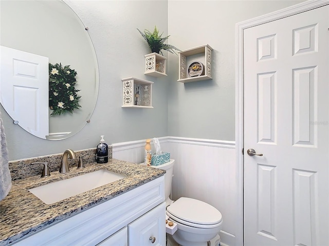 bathroom featuring toilet and vanity