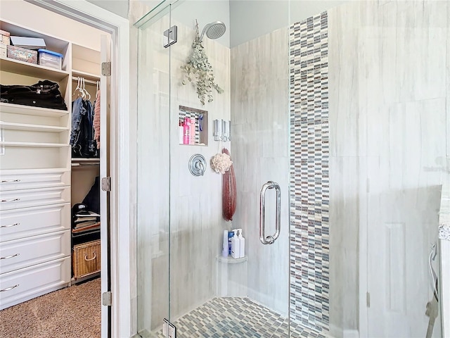 bathroom featuring a shower with door