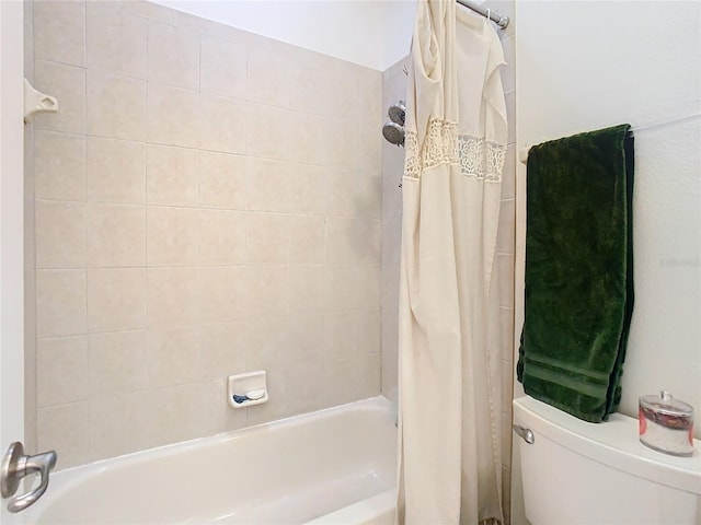 bathroom with shower / bath combo and toilet