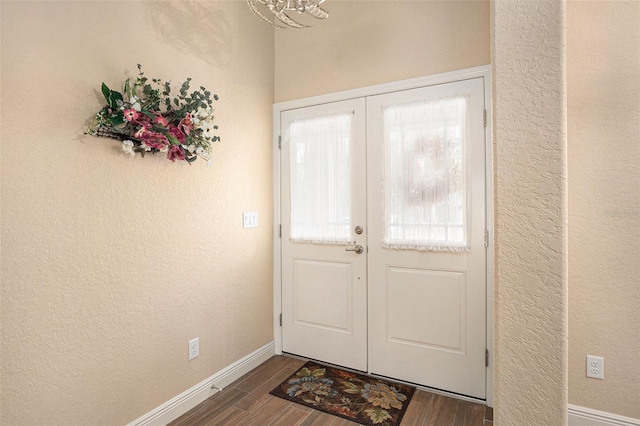 foyer with french doors and dark wood-type flooring