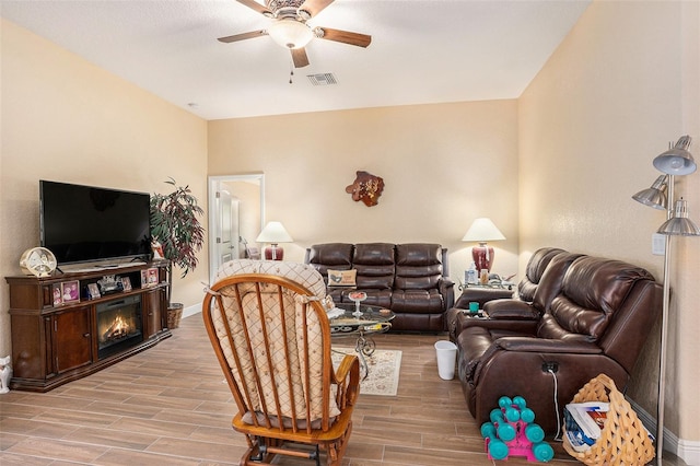 living room featuring light hardwood / wood-style flooring and ceiling fan