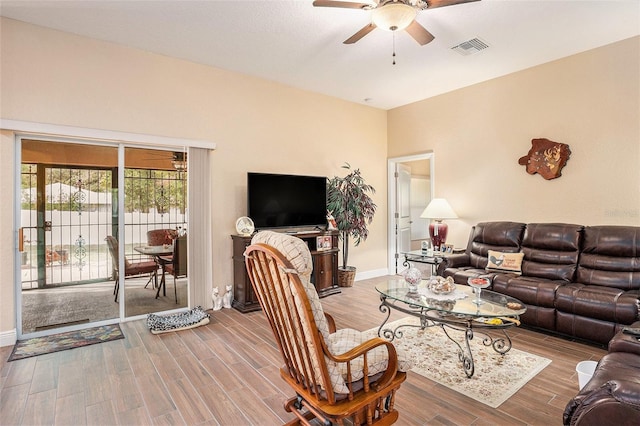 living room featuring hardwood / wood-style flooring and ceiling fan