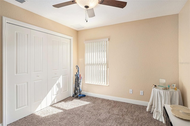 unfurnished bedroom featuring a closet, ceiling fan, and carpet floors