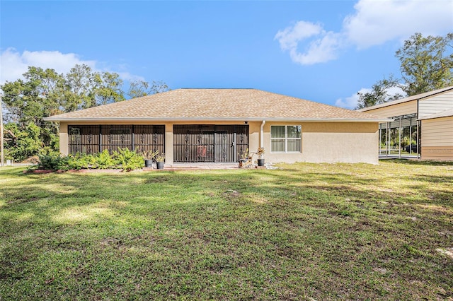 rear view of property with a lawn