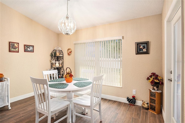 dining area featuring a notable chandelier and dark hardwood / wood-style floors