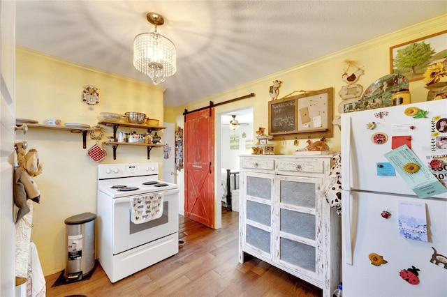 kitchen featuring hardwood / wood-style floors, white appliances, hanging light fixtures, a barn door, and ornamental molding