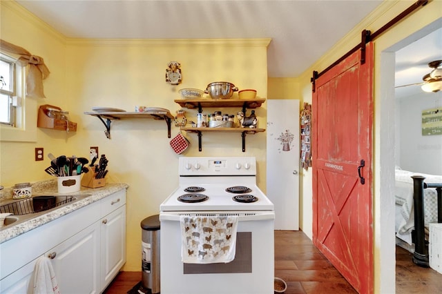 kitchen featuring crown molding, a barn door, white cabinetry, dark hardwood / wood-style floors, and white range with electric cooktop