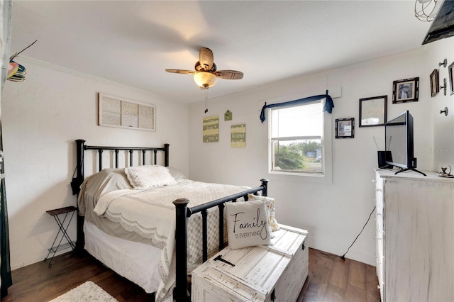 bedroom with ceiling fan and dark hardwood / wood-style floors